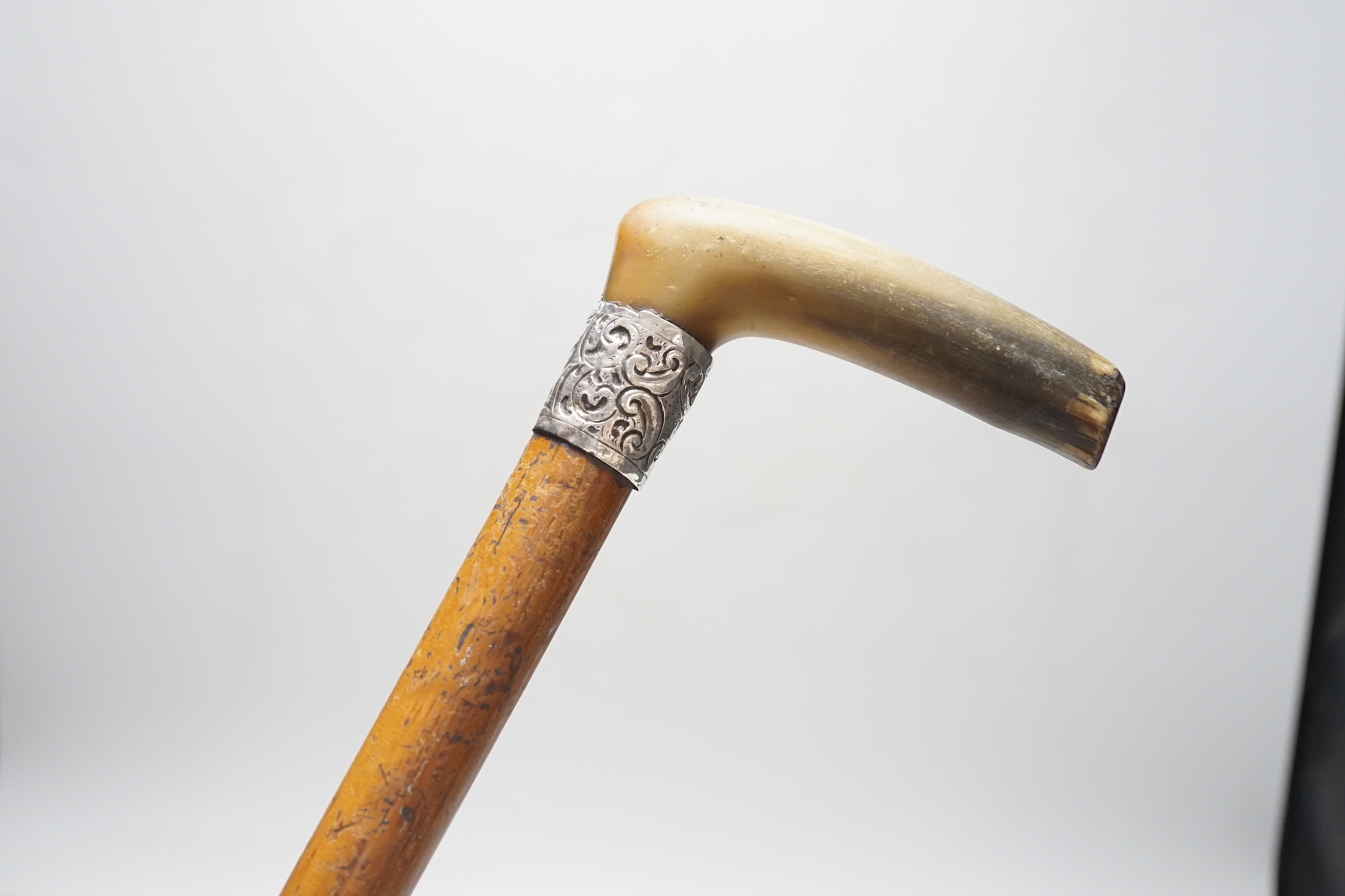 A George V silver and tortoiseshell five piece dressing table set and a silver mounted horn handled malacca walking stick.